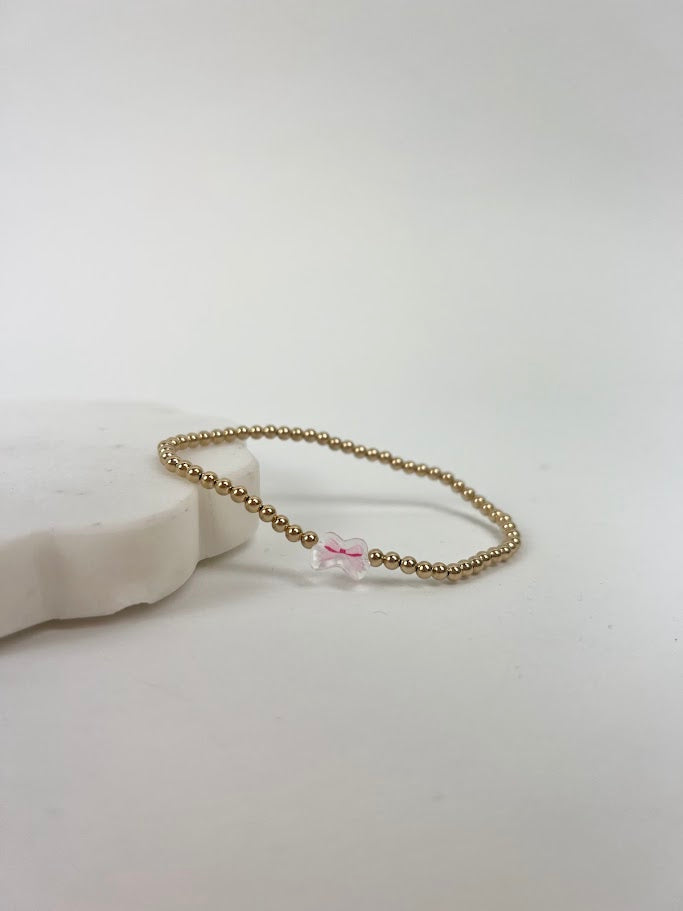 Beaded Blondes Pink Bow Charm Bracelet Bracelets in at Wrapsody