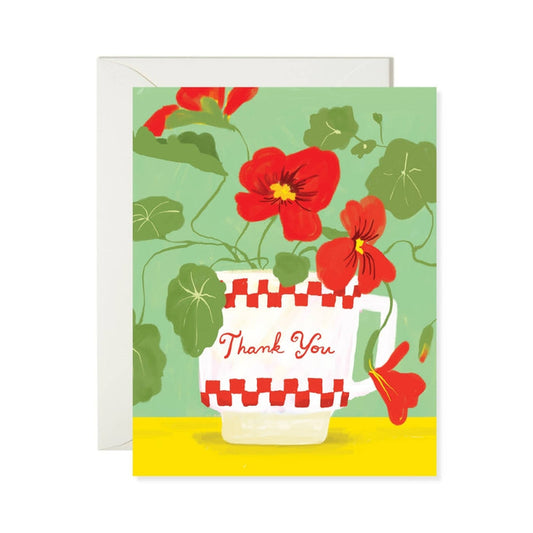 Greeting card with red flowers and a checkered mug on a green background
