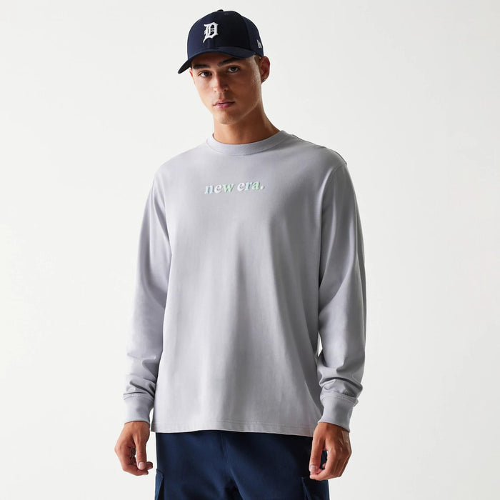 The Male model is wearing New Era 90s Vibe Grey Long Sleeve T-Shirt 1