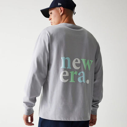 The Male model is wearing New Era 90s Vibe Grey Long Sleeve T-Shirt 2