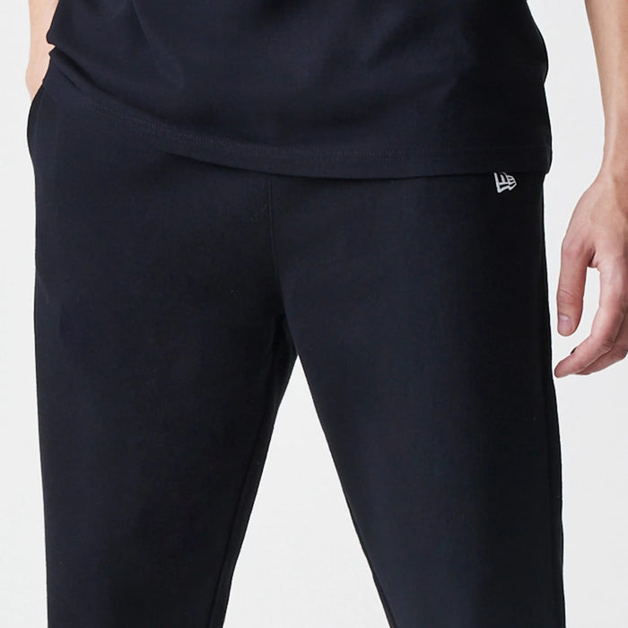 The Male model is wearing New Era Premium Essential Black Joggers 4