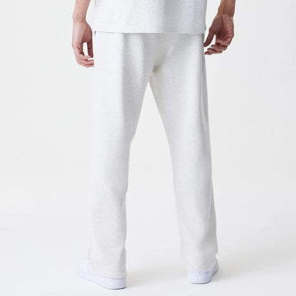 The Male model is wearing New Era Premium Essential Pastel Grey Joggers 2