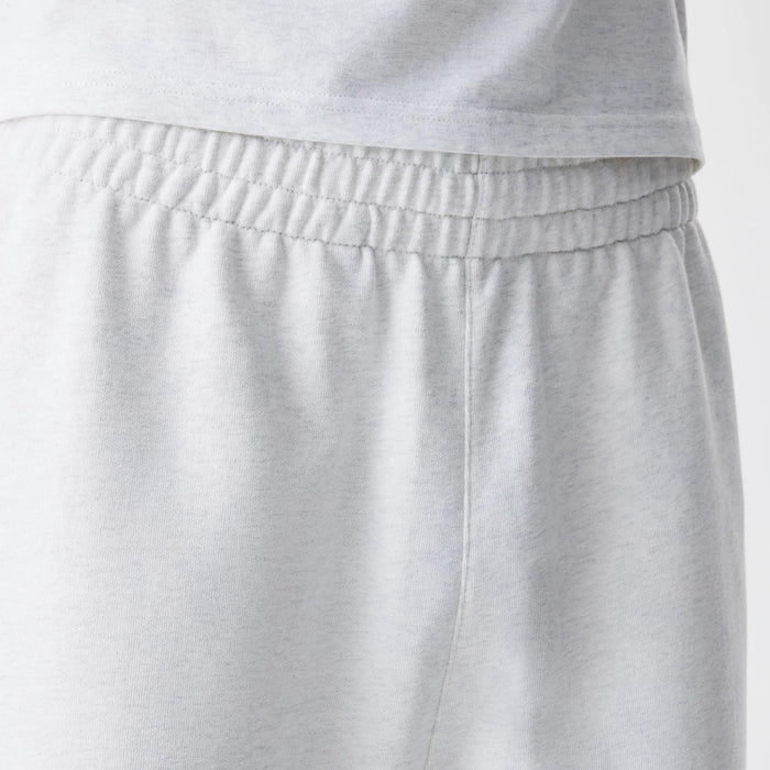 The Male model is wearing New Era Premium Essential Pastel Grey Joggers 6