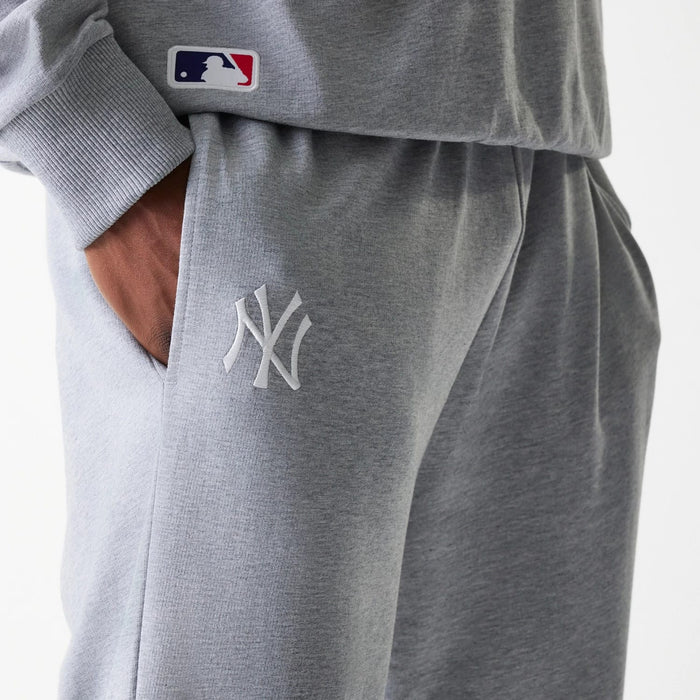 The Male model is wearing New York Yankees MLB League Essential Midi Grey Joggers 4