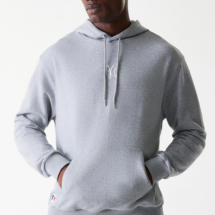 The Male model is wearing New York Yankees MLB League Essential Midi Grey Oversized Pullover Hoodie 3