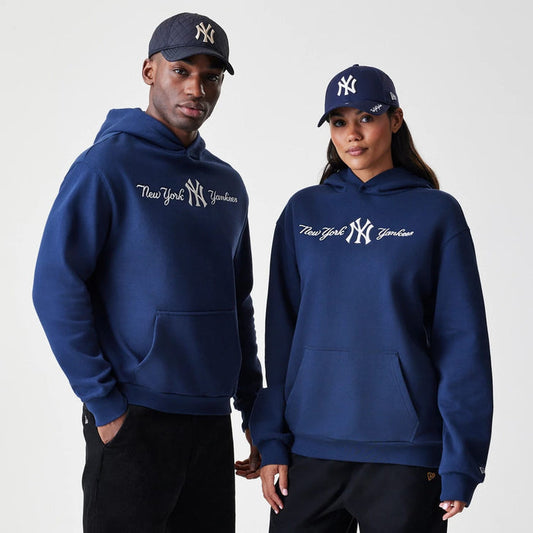 The Male model is wearing New York Yankees MLB Script Navy Oversized Pullover Hoodie 1